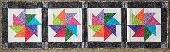 57 by 16 inches. Reversible table runner