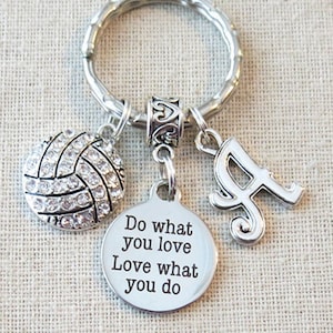 May include: Silver keychain with a volleyball charm, a letter A charm, and a round charm with the text "Do what you love Love what you do".