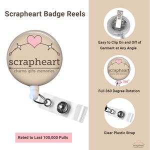 May include: A badge reel with a round design featuring a pink heart and the text "scrapheart charms. gifts. memories." The reel has a clear plastic strap and a clip for attaching to clothing. The text "Rated to Last 100,000 Pulls" is also visible.