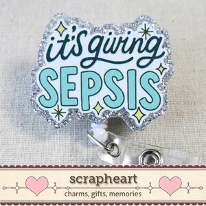 May include: A badge reel with the phrase "it's giving SEPSIS" in teal and black lettering, outlined in white. The badge has a silver glitter border and star accents. The reel has a clear plastic clip and a white retractable cord.