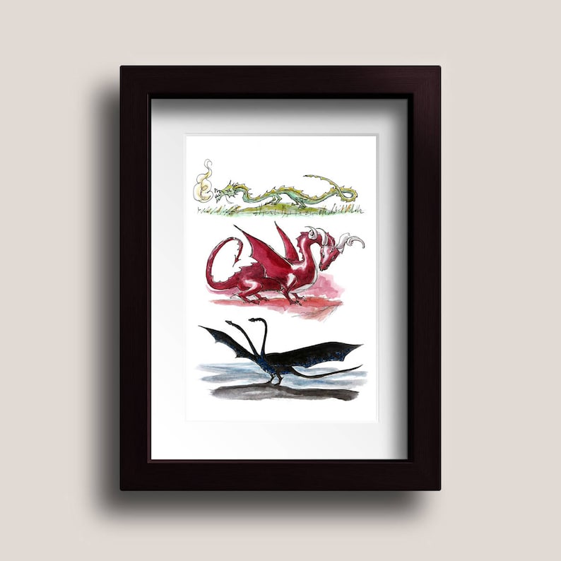 May include: A framed print of three dragons, one green, one red, and one black. The dragons are drawn in a whimsical style with watercolor.