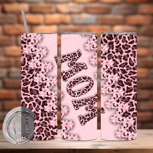 May include: Three pink and brown leopard print tumblers with a pink background and the word "MOM" in leopard print on the middle tumbler.