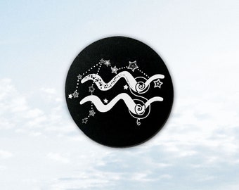May include: Black circle with a white astrological symbol for Aquarius, surrounded by white stars.