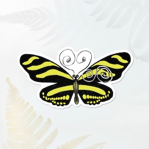 May include: A black and yellow butterfly sticker with a white swirl design. The butterfly has black stripes and yellow spots.