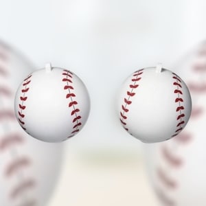 May include: Two white baseballs with red stitching. The baseballs are in focus and the background is blurred.