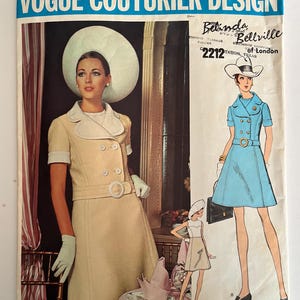May include: A vintage Vogue Couturier Design sewing pattern featuring two women's dresses. The pattern is for a dress with a double-breasted closure, a belt, and a short skirt. The pattern number is 2212. The designer is Belinda Bellville of London.