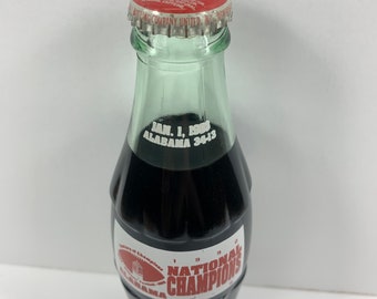 Vintage collectible Coca Cola Classic bottle commemorating 1992 Alabama Football National Champions 13 - 0. Original beverage sealed inside.