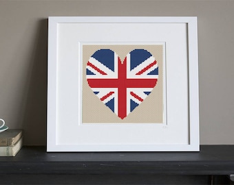 May include: A framed cross-stitch design of a heart-shaped Union Jack flag. The heart is red, white, and blue with a white background.
