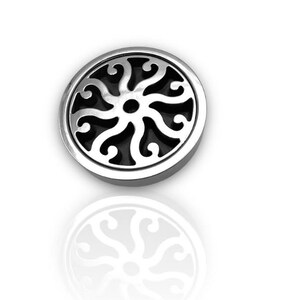 May include: A silver circular pendant with a black, intricate, floral design. The pendant has a raised edge and a smooth, reflective surface.