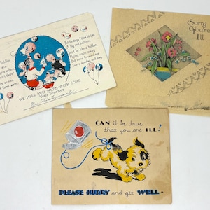 May include: Three vintage greeting cards. One card has a blue circle with children playing with bubbles and the text "WE MISS YOU WHEN YOUR GONE". Another card says "Sorry You're Ill" with a floral design. The third card has a cartoon dog and the text "CAN it be true that you are ILL!"