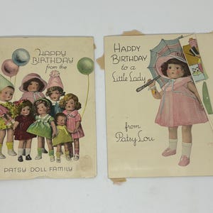 May include: A white ceramic mug with a black handle and the text "But First, Coffee" in a bold, black font. The mug is set against a blurred background, suggesting a cozy setting.