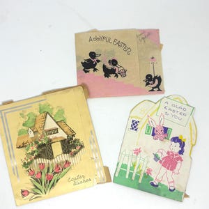 May include: Three vintage Easter greeting cards. One card features a cottage with tulips, another has ducks, and the third shows a girl with a watering can and a bunny. The cards are in various shapes and colors.