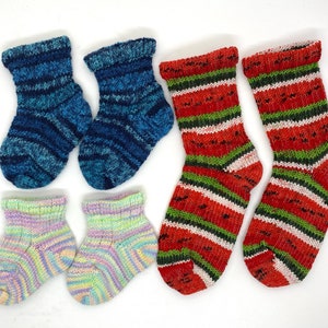 May include: A set of six colorful socks, including two pairs of striped socks in red, white, and green, one pair of blue and white striped socks, and one pair of pastel pink and green striped socks.