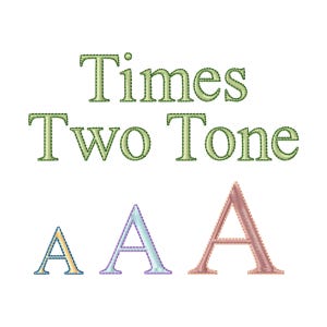 May include: The text Times Two Tone is embroidered in a light green serif font with a darker green outline. Below the text are three capital letter A characters in different sizes and colors: a small yellow A, a medium light blue A, and a large pink A.