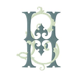 May include: An embroidered letter H in a dark slate blue colour, featuring a decorative light mint green filigree pattern that weaves through the centre and extends outward with curved, leafy flourishes and a central fleur-de-lis motif.