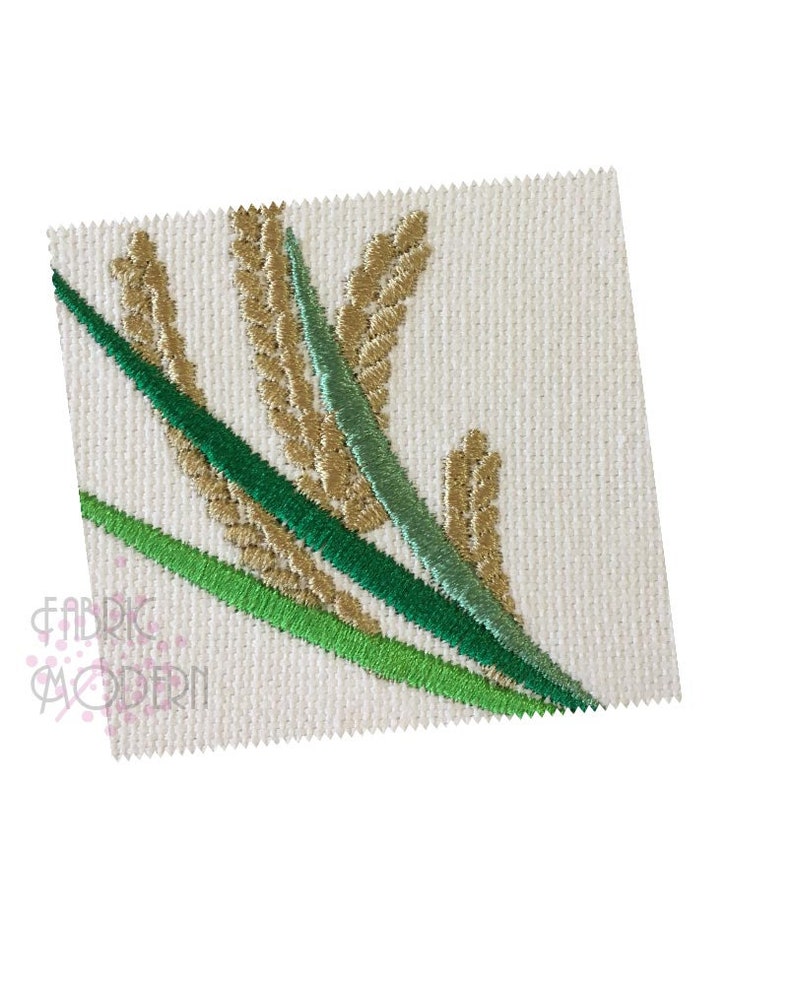 以下が含まれることがあります： 白い布地に、緑の葉が付いた小麦の穂の刺繍デザイン