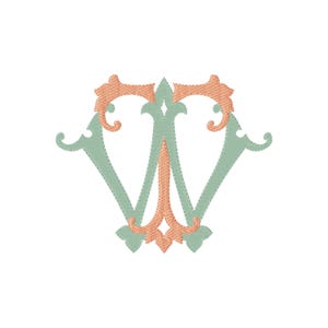 May include: An embroidered monogram featuring the letter W in a sage green thread, accented with peach-colored decorative flourishes at the top and bottom. The design displays a stitched texture throughout, creating a clear, layered appearance.