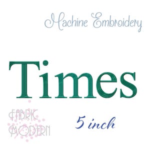 May include: A digital embroidery design file featuring the word Times in a dark teal serif font. The text Machine Embroidery appears in light gray above, while the text 5 inch appears in dark blue below. The logo Fabric Modern is in the corner.