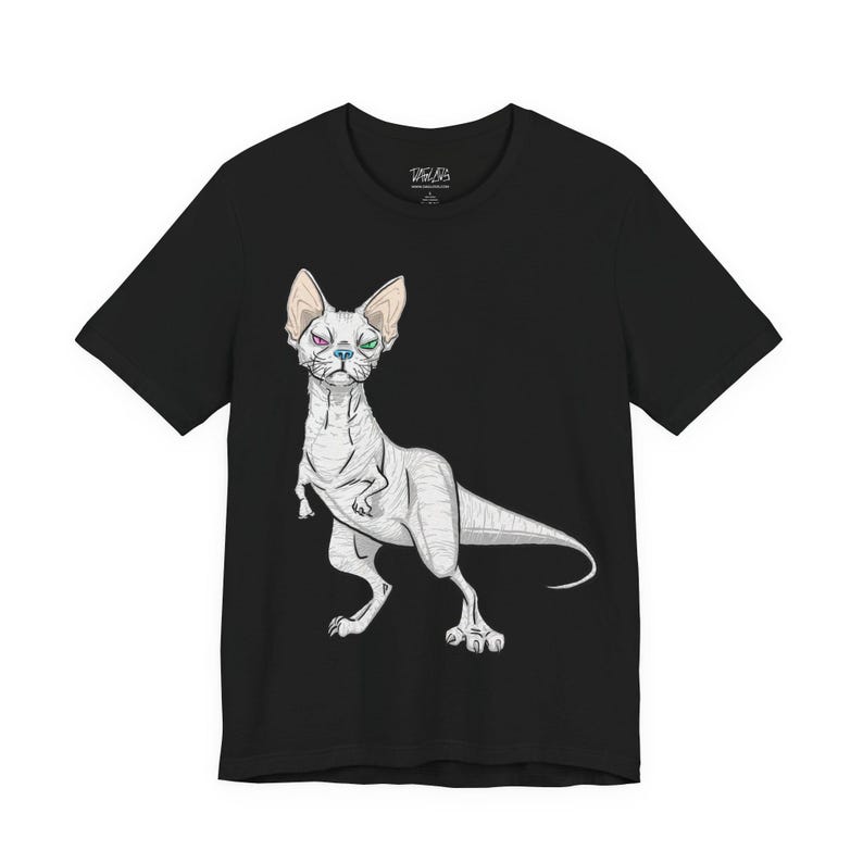 May include: A black short-sleeve t-shirt featuring a graphic illustration of a hairless cat with a dinosaur-like body, a long tail, and heterochromia with one purple eye and one green eye, centered on the front of the garment.
