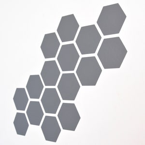 May include: A grey honeycomb pattern made of hexagons. The hexagons are arranged in a staggered pattern, creating a visually appealing design.