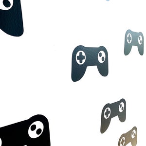May include: A white background with multiple black and white video game controller silhouettes.