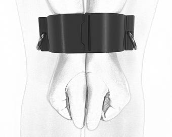 May include: Black leather wrist restraints with silver metal rings. The restraints are adjustable and have a smooth, matte finish.