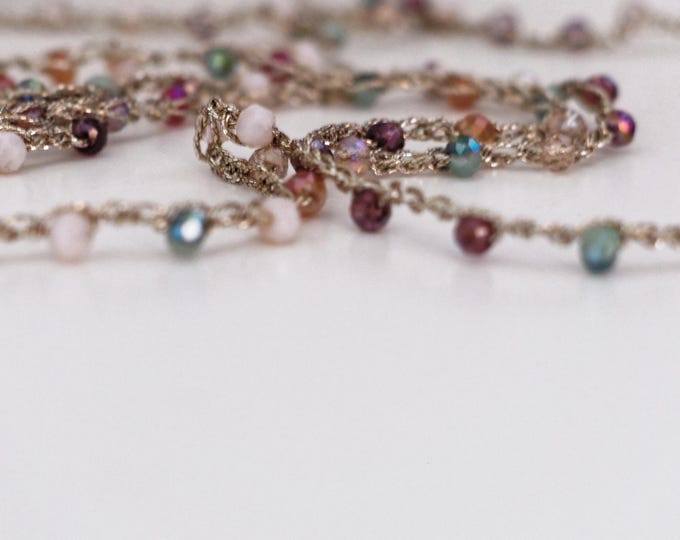 Long crochet necklace with golden thread and crystals, Textile jewel by Piera Romeo