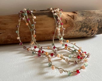 Long crochet necklace with golden thread and crystals, Textile jewel by Piera Romeo