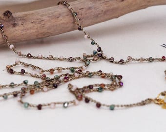 Long crochet necklace with golden thread and crystals, Textile jewel by Piera Romeo
