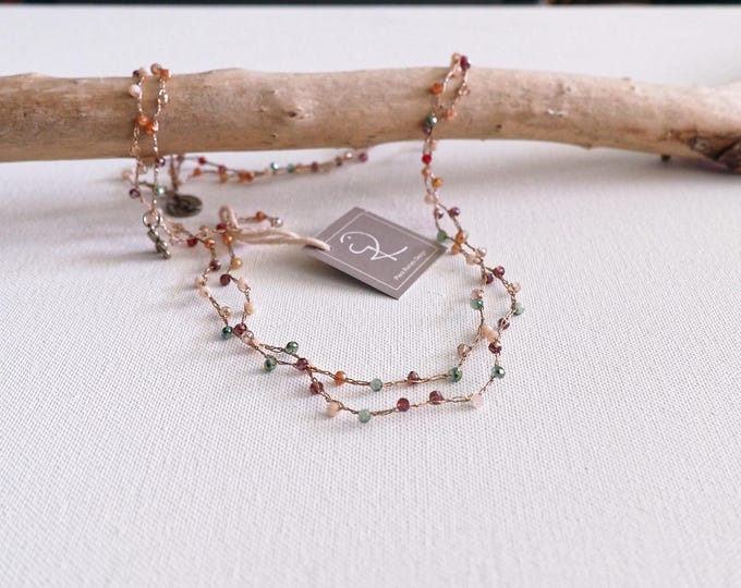 Long crochet necklace with golden thread and crystals, Textile jewel by Piera Romeo
