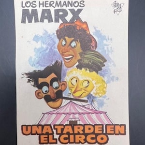 May include: Vintage movie poster for "Los Hermanos Marx" featuring cartoon caricatures of the Marx Brothers. The poster has the title "Una Tarde En El Circo" and the director's name, Edward Buzzell, in a circus theme.