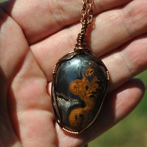 Hematite jasper pendant; wire wrapped stone; copper wire wrap; handmade necklace; oval pendant; gemstone necklace; dark gray yellow stone