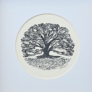 May include: A framed print of a black and white illustration of a large tree with a circular border. The tree is surrounded by a pattern of small, repeating shapes.