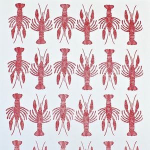 This is an original hand carved block print of a red crawfish or lobster pattern in four rows on fine art paper.