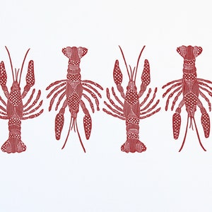 This is an original hand carved block print of a red crawfish or lobster pattern on fine art paper.