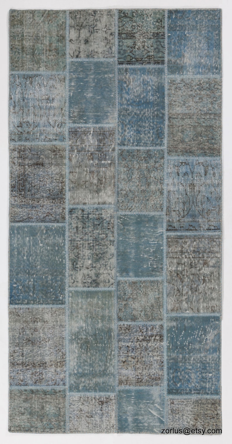 Faded Blue and Grey Patchwork Rug. Soft Pastel coloured patches of overdyed rugs stitched together to make a contemporary rug