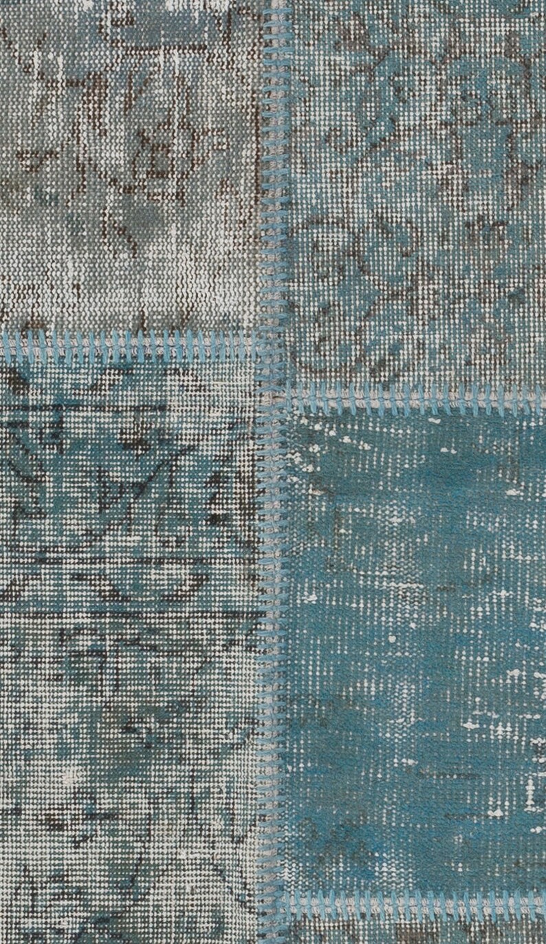 Faded Blue and Grey Patchwork Rug. Soft Pastel coloured patches of overdyed rugs stitched together to make a contemporary rug