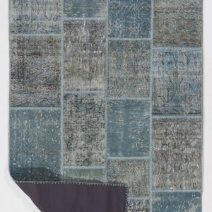 Faded Blue and Grey Patchwork Rug. Soft Pastel coloured patches of overdyed rugs stitched together to make a contemporary rug