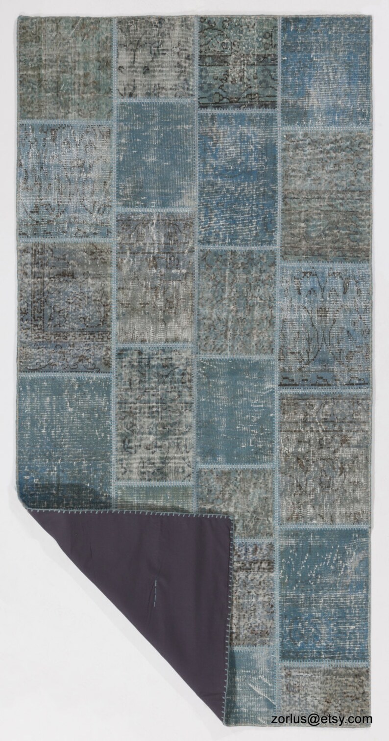 Faded Blue and Grey Patchwork Rug. Soft Pastel coloured patches of overdyed rugs stitched together to make a contemporary rug