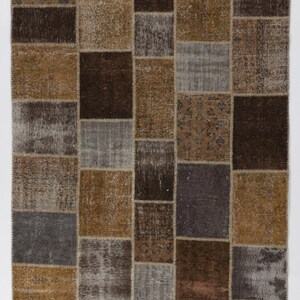 May include: A patchwork rug with a variety of brown, beige, and gray squares. The rug has a distressed look and is made from recycled materials.