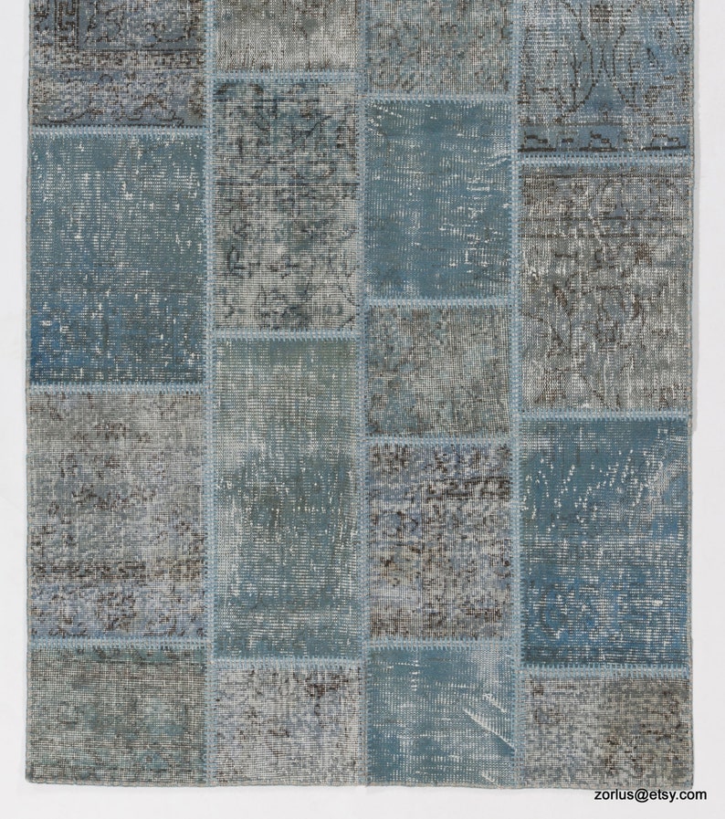 Faded Blue and Grey Patchwork Rug. Soft Pastel coloured patches of overdyed rugs stitched together to make a contemporary rug
