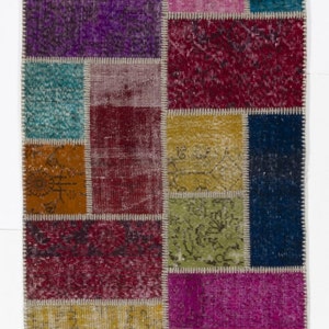 May include: A colorful patchwork rug with a variety of colors and patterns, including red, blue, green, yellow, and purple. The rug is made of recycled materials and has a unique, hand-woven look.