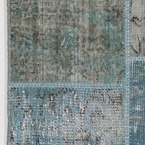 Faded Blue and Grey Patchwork Rug. Soft Pastel coloured patches of overdyed rugs stitched together to make a contemporary rug
