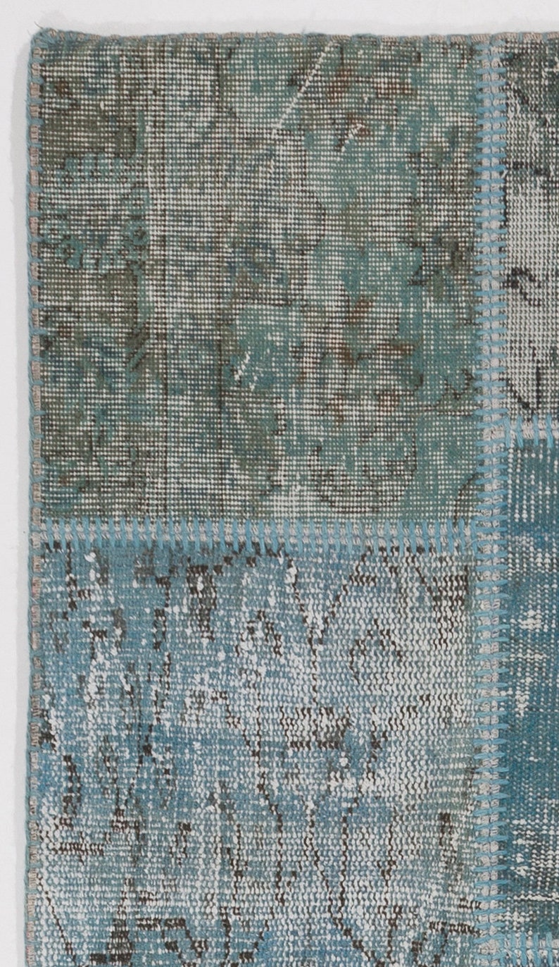 Faded Blue and Grey Patchwork Rug. Soft Pastel coloured patches of overdyed rugs stitched together to make a contemporary rug