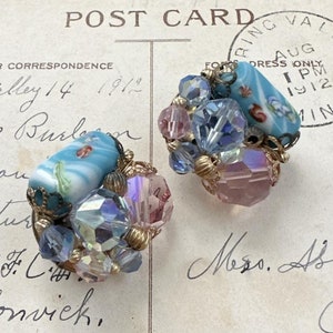May include: A pair of vintage earrings with blue and pink glass beads and a blue and white cameo. The earrings are on a postcard with the text "FOR CORRESPONDENCE Valley 14 1912" and a postmark from August 1912.