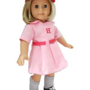 May include: A pink baseball uniform with a red belt and a red cap with a white "H" on it. The doll is wearing grey socks and black sneakers.