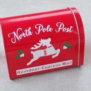 May include: Red metal mailbox with a white reindeer and the text "North Pole Post" and "Reindeer Express Mail".
