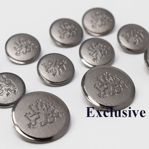 May include: A set of ten silver-toned buttons with a raised lion design. The buttons are round and have a smooth, polished finish.  Exclusive Buttons.