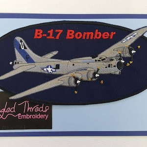 May include: A blue oval embroidered patch with a gray B-17 bomber airplane on a dark blue background. The patch has the text "B-17 Bomber" in red lettering and the text "Tangled Threads Embroidery" in pink lettering.
