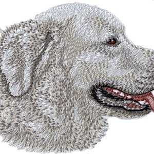 May include: A detailed illustration of a dog's head in profile. The dog has a fluffy, light gray coat with darker shading. Its eyes are brown, and its mouth is open, revealing a pink tongue and teeth. The image is set against a white background.
